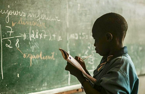 Child looking at chalk board